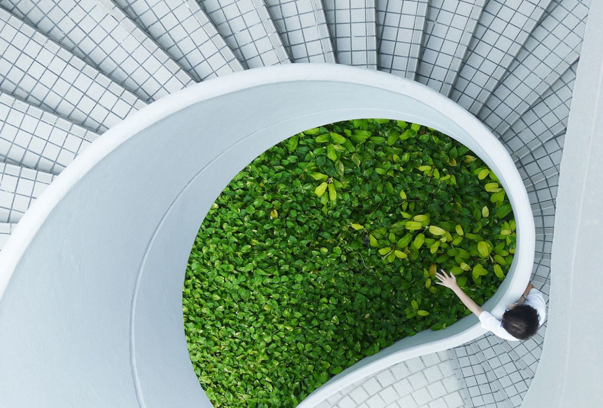 impact-block.jpg A spiral of stairs leading to a patch of grass