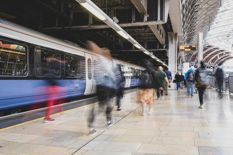 Rail passengers walking along platform